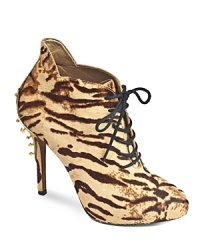 A studded gold-tone plate offers an unexpected finish on Sam Edelman's wild, animal-printed calf hair booties.