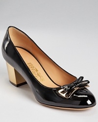 With rich metallic accents, these classic Salvatore Ferragamo pumps add a timeless touch.