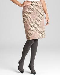 Embrace classic femininity in a sleek Tory Burch skirt accentuated by crisp plaid for retro flair.