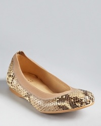 Flexible elastic trim adds low-key comfort to exotic snakeskin printed leather. From Stuart Weitzman.