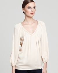 Simple yet elegant, this peasant-style DIANE von FURSTENBERG top, neutralizes basic black or dark wash skinnies.