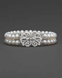 Double stranded bracelet of cultured, freshwater pearls accented with a diamond bow clasp.