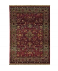 A truly charming interpretation of a traditional carpet, this rug features a center medallion ringed by palmettes and floral details in sage green, topaz and slate blue against a rich burgundy ground. Striated effects create the weathered look of handmade rugs in a stain-resistant, no-shed manmade fiber.