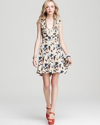 This Juicy Couture dress goes full-on feminine with decadent neckline ruffles and a playful iris print.