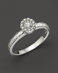 Faceted diamond set in a textured 14K. white gold band.