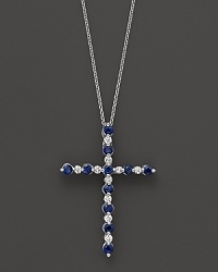 Diamonds and sapphires in a 14K white gold cross pendant on a fine chain.