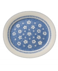 Vintage charm meets modern durability in the Farmhouse Touch oval platter, featuring cornflower-blue laurels and blooms in premium porcelain from Villeroy & Boch.