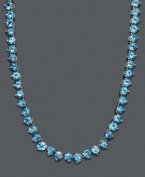 Cool down your look in icy blue hues. This vibrant necklace features a seamless row of round-cut blue topaz (45 ct. t.w.) set in sterling silver. Approximate length: 17 inches.