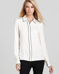 Rachel Zoe reinvents the classic button down with chic contrast piping and shoulder-squaring epaulets.