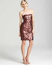 Leather-like metallic triangles lend a modern, geometric look to a strapless Aidan Mattox dress.