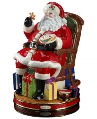 Santa at his merriest. In a classic depiction of St. Nick, Christopher Radko's heirloom Christmas figurine is rich with detail, from colorfully wrapped presents to a plate of fresh cookies.