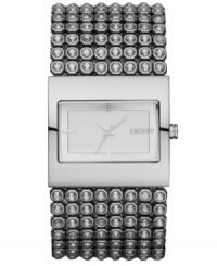 Bare your bling. This gorgeous DKNY watch features a crystal-accented stainless steel bracelet and rectangular case. Matte silvertone sunray dial with silvertone stick indices and logo. Quartz movement. Water resistant to 30 meters. Two-year limited warranty.