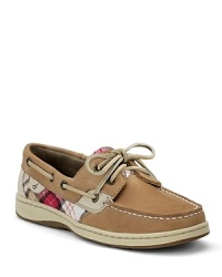 In tanned leather and classic plaid, a rustic look shines on a classic pair of boat shoes from Sperry Top-Sider.