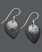 Embrace the boho-chic styles of Jody Coyote. This free-spirited pair of earrings feature teardrop-shaped black patina bronze and a circular sterling silver charm. Approximate drop: 1-1/8 inches.