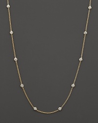 Diamond stations punctuate a long, elegant 18K yellow gold chain. By Roberto Coin.