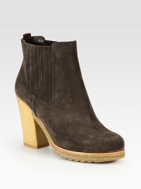 Suede ankle boot with a crepe sole and elastic gores. Rubber heel, 4 (100mm)Rubber platform, ½ (15mm)Compares to a 3½ heel (90mm)Suede upperBack pull-tab and side elastic goresLeather liningRubber trek solePadded insoleImported