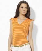 A classic sleeveless tee is updated with chic ruched detailing at the arms in this Lauren by Ralph Lauren look.