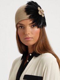 This wool-blend knit topper with large feather design is reminiscent of old Hollywood style.Pull-on style with concealed elastic band80% wool/20% polyesterDo not washImported