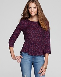 A playful peplum lends a feminine flounce to this silky-soft, polka-dotted Ella Moss top.