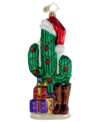 Deck the desert. A cacti in a Christmas hat, plus a pair of cowboy boots and longhorn-patterned wrapping paper make this hand-painted ornament essential to holidays in the American Southwest. By Christopher Radko.