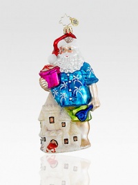 Everyone needs a break! A Hawaiian shirt-clad Santa makes a pit stop at the beach to make some impressive sandcastles. Hand-blownHand-painted5½ tallMade in Poland