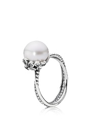 A white freshwater pearl rests in an elegant floral setting while delicately intertwined sterling silver bands complete the sweetly romantic look. Ring by PANDORA.