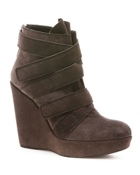 Stuart Weitzman goes wild with these fashion-forward wedge booties that are all wrapped up in the strap trend.