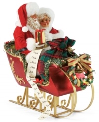 He's making a list and checking it twice! This festive figurine captures the age-old tradition of sitting on Santa's lap and telling him what gifts you want for Christmas.