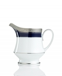 Formal white fine china displays a dramatic combination of scrolling leaves on shimmering platinum and an inner band of intense cobalt blue. Dishwasher safe.