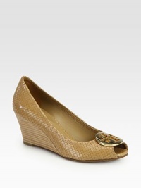 Walk confidently wearing this textured snake-print leather design with a stacked wedge, goldtone medallion and classic peep toe. Stacked heel, 2½ (65mm)Snake-print leather upperPeep toeLeather liningRubber solePadded insoleImported