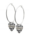 Get chic, city style in urban-inspired hoops. GUESS's non-traditional hoop earrings feature a heart charm decorated with the company logo in scrawling graffiti and sparkling jet crystals. Crafted in silver tone mixed metal. Approximate drop: 1 inch. Approximate hoop diameter: 1-1/2 inches.