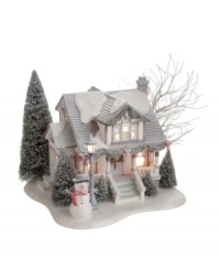 A friendly snowman stands watch over the picture-perfect Cottagewood Bungalow, one of the most charming in the Village. Although snow continues to fall outside, it's warm inside and smells of Christmas cookies baking in the oven. From Department 56.