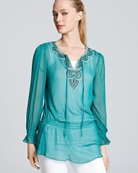 Escape the everyday in this Shiloh770 tunic, splashed with with an aquatic hue and peppered with gleaming embellishment for the ultimate fashion trip.