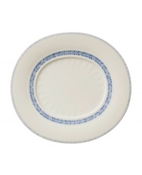 Vintage charm meets modern durability in the Farmhouse Touch oval gourmet plate, featuring cornflower-blue laurels and bands in delicately embossed porcelain from Villeroy & Boch.