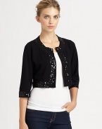 Glimmering sequins lend a glam touch to this boxy knit bolero.Round necklineLong sleevesOpen frontAbout 15 from shoulder to hem80% rayon/20% nylonDry cleanImported