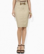 An elegant pencil skirt silhouette is crafted in neutral denim and finished with a heritage faux-suede buckle at the front.