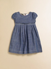 A captivating frock in soft chambray, with a crisply pleated Empire waist and sweet puffed sleeves.Round neckline with topstitchingShort puffed sleevesEmpire waist with stitched pleatsFull button back with check trimCottonMachine washImported Please note: Number of buttons may vary depending on size ordered. 