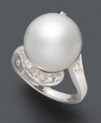 A timeless addition to your collection. This polished, versatile ring highlights a cultured South Sea pearl (13-14 mm) accented by sparkling round-cut diamonds (1/3 ct. t.w.). Set in 14k white gold.