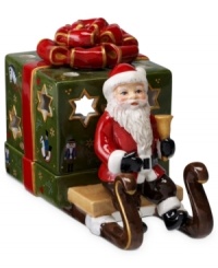 Santa Claus carries a brilliant surprise on the back of his sleigh in this beautifully crafted candle holder from Villeroy & Boch. Light shines through pierced stars in a present wrapped in charming vintage style.