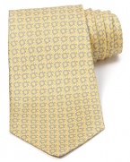 Repeating Gancini logos are rendered in two complementary colors and patterned with a whimsical design on this superior silk tie, offering a bit of refined luxury for the modern man.