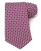 Slick dolphins do their tricks atop a classic silk tie from Salvatore Ferragamo.