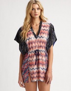 Contrasting patterns flawlessly combine to create this v-neck caftan with a flattering drawstring waist.V-neckKimono sleevesDrawstring waistSide slitsPull-on styleRayon/polyesterHand washMade in Italy of imported fabric