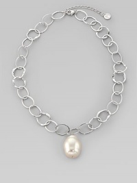 A large, lustrous white pearl drop dangles with creamy iridescence from a silvery chain of hammered open links. 22mm white baroque organic man-made pearl Rhodium-plated sterling silver Length, about 16, with 2 extender Lobster clasp Made in Spain