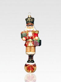 An exquisite ornament created by skilled artisans who capture all the traditional charm of a holiday nutcracker in a delicate, timeless glass design. Painted, glittered glass 7 high Made in Poland 