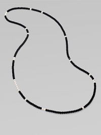 From the Night Blue Collection. This high contrast piece features a long strand of flocked velvet beads punctuated by pearlized glass beads. Length, about 49½ Slip-on style Imported 