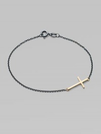 A gleaming 14k gold cross on an oxidized sterling silver chain.14k yellow gold Oxidized sterling silver Length, about 7 Pendant length, about ¾ Spring ring clasp Made in USA