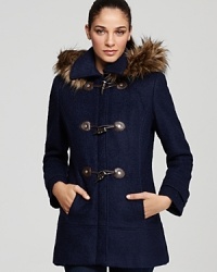 This classic Calvin Klein coat boasts smart toggle closures and glam faux fur for a trend-right look to elevate your daily style.