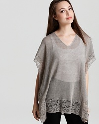 Intricate knit lace lends feminine appeal to a breezy Eileen Fisher tunic. Balance the boxy silhouette with sleek separates for effortless sophistication.