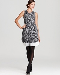 The look of the lady, a fit-and-flare DKNY dress embraces a classic vision of femininity as delicate pleats inspire an intricate lace print. Polish off the look with pearls and delight in the romance of it all.