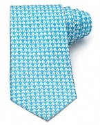 A classic silk tie from Salvatore Ferragamo, showcasing a charming chick print.